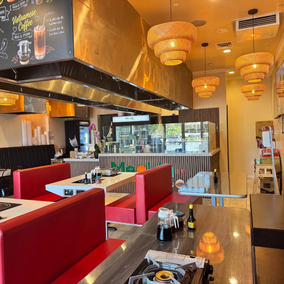 Booth seating and tabletop cooktops at Meokja.